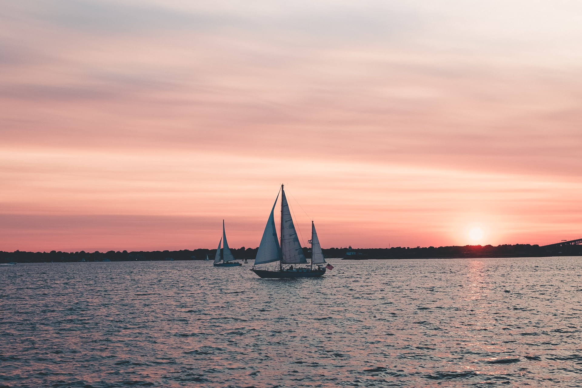 Sailboats moored on Narragansett Bay at sunset, pink sky over Barrington, Rhode Island